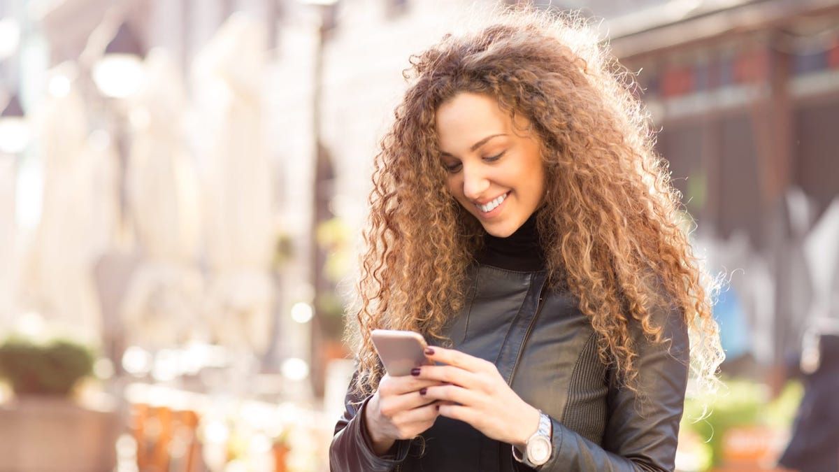 Woman using phone chat line to meet new people